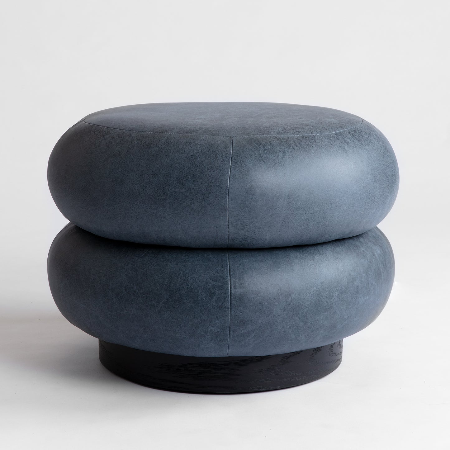 Shown in Oxidized Oak base finish and upholstered in leather